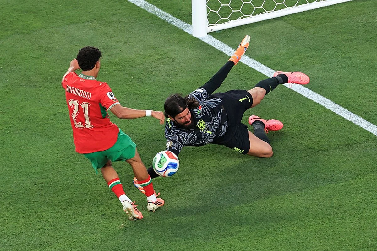 EAST RUTHERFORD, NEW JERSEY - JUNE 13: Brazil goalkeeper Alisson Becker makes a late save from a Ayoube Amaimouni-Echghouyab of Morocco shot during the FIFA World Cup 2026 Group C match between Brazil and Morocco at New York New Jersey Stadium on June 13, 2026 in East Rutherford, United States. (Photo by Simon Stacpoole/Offside/Offside via Getty Images)