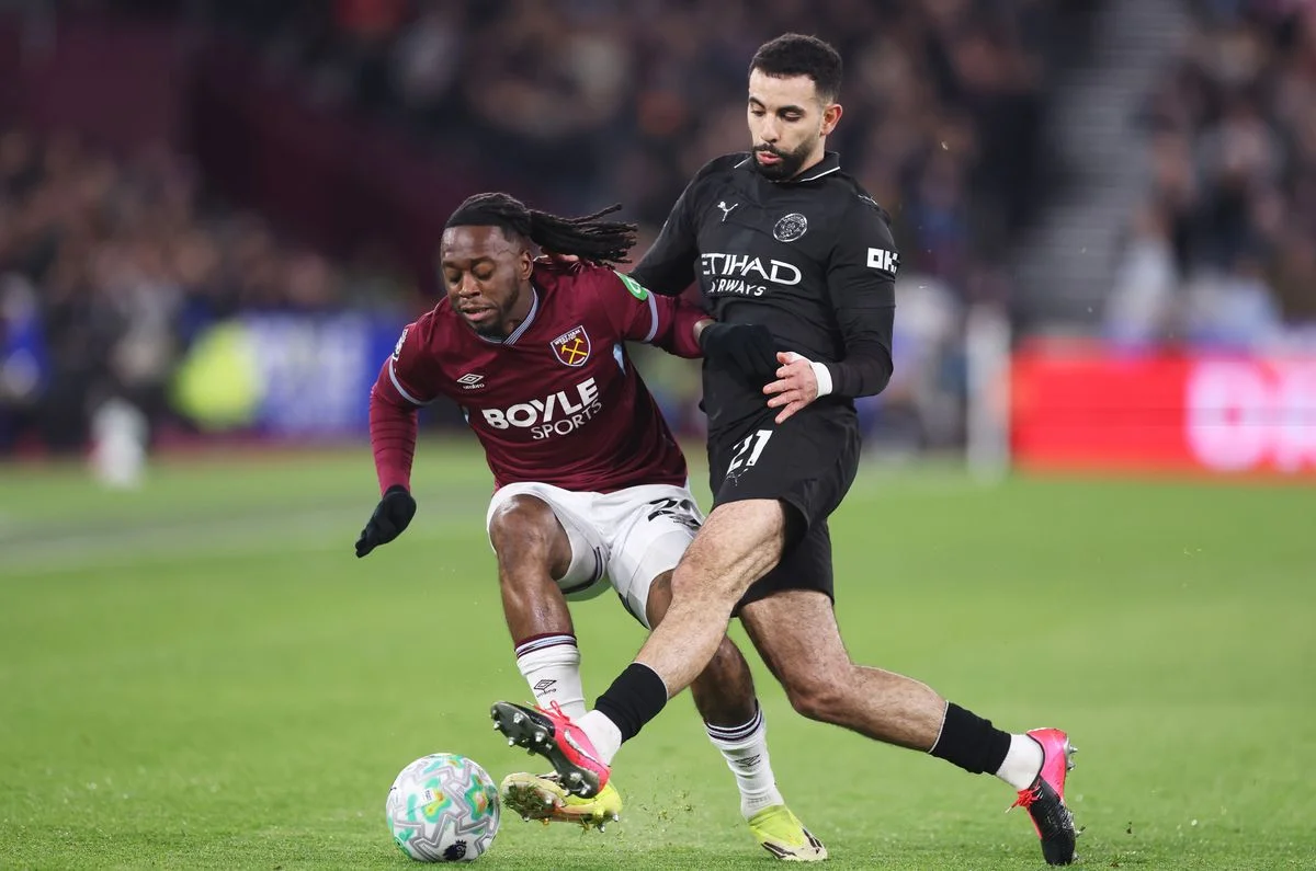 LONDON, ENGLAND - MARCH 14: Aaron Wan-Bissaka of West Ham United is challenged by Rayan Ait-Nouri of Manchester City during the Premier League match between West Ham United and Manchester City at London Stadium on March 14, 2026 in London, England. (Photo by Julian Finney/Getty Images)