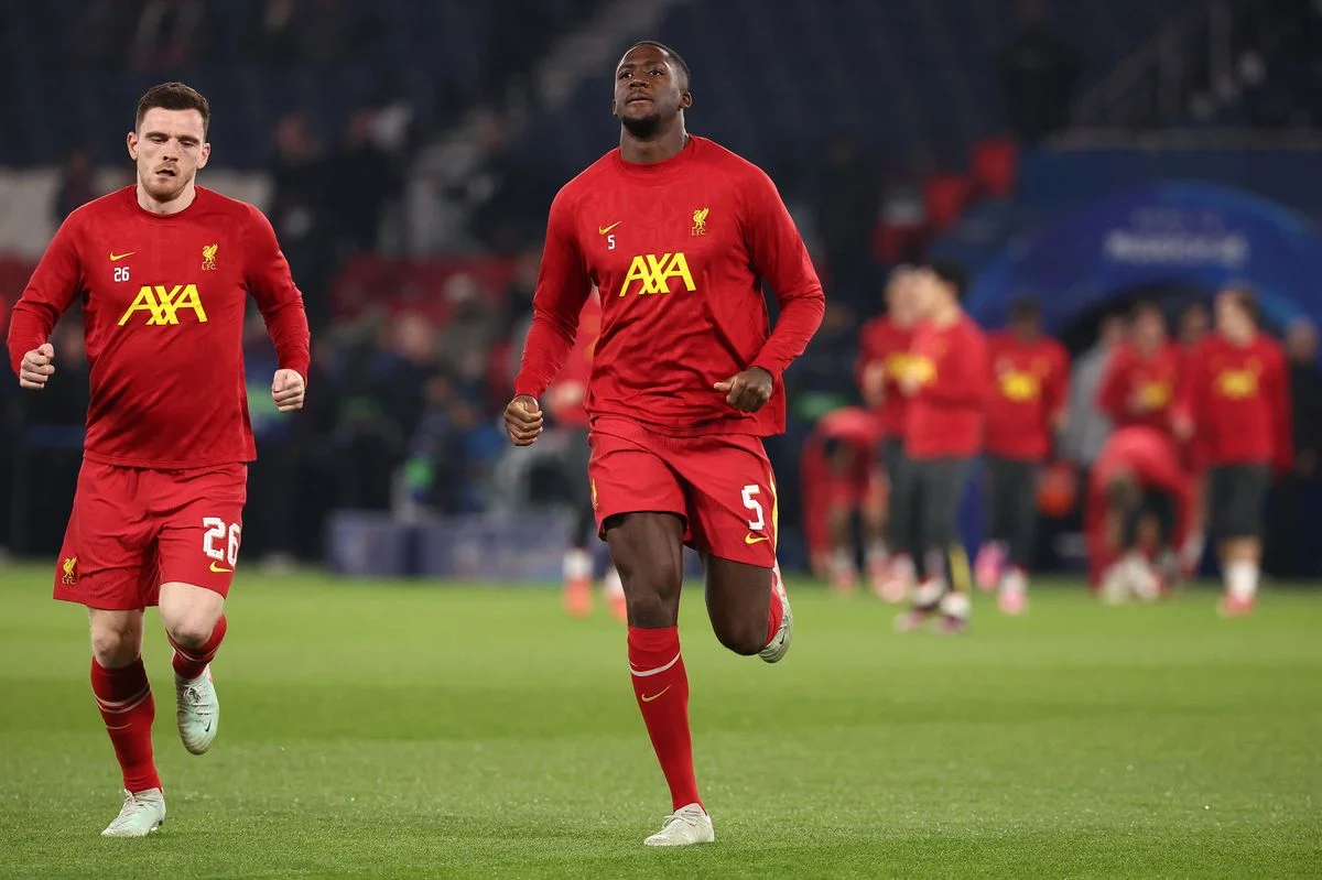 Liverpool's Scottish defender #26 Andrew Robertson (L) and Liverpool's French defender #05 Ibrahima Konate (C) warm up ahead of the UEFA Champions League Round of 16 first leg football match between Paris Saint-Germain (FRA) and Liverpool (ENG) at the Parc des Princes stadium in Paris on March 5, 2025. (Photo by FRANCK FIFE / AFP via Getty Images)