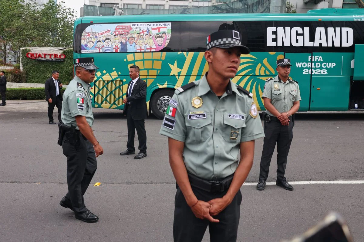 Members of the national guard stand next to the bus that transported England's national football team players from the Marriott Hotel to a training session ahead of their FIFA World Cup 2026 match against Mexico, in Mexico City. Photo by Claudia Rosel / AFP via Getty Images